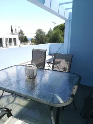 a blue table and chairs on a patio at Mina’s Villa, 200m from the beach in Porto Rafti