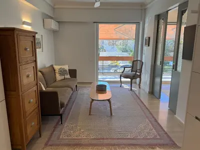 a living room with a couch and a table at Peter's Place in Athens