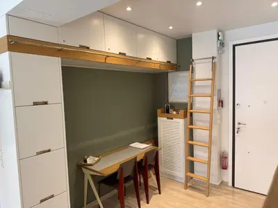 a room with a table and a loft bed at Peter's Place in Athens