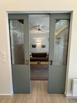 an open door into a living room with a couch at Peter's Place in Athens