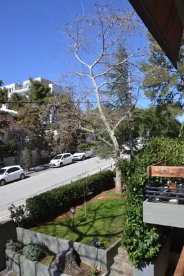 a view of a street with a bench and a tree at Peter's Place in Athens