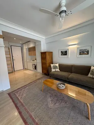 a living room with a couch and a coffee table at Peter's Place in Athens