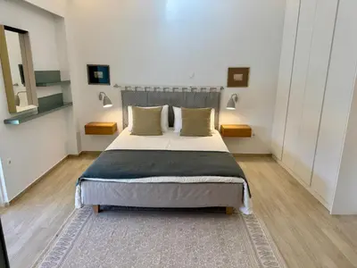 a bedroom with a large bed in a room at Peter's Place in Athens