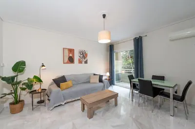 a living room with a couch and a table at Cozy 1Bdrm Apt/walk to the beach in Athens