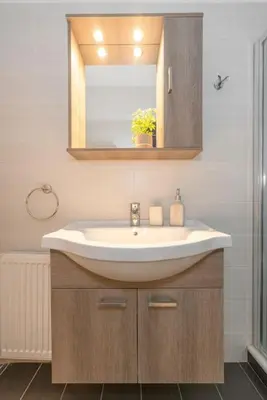 a bathroom with a sink and a mirror at Cozy 1Bdrm Apt/walk to the beach in Athens