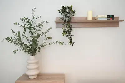 a white vase sitting on a shelf with a plant at Cozy 1Bdrm Apt/walk to the beach in Athens