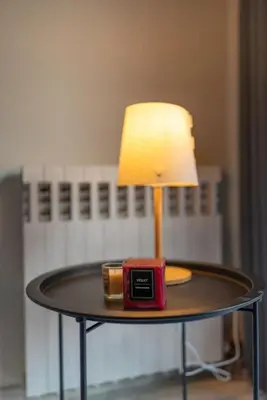 a table with a lamp and a clock on it at Cozy 1Bdrm Apt/walk to the beach in Athens