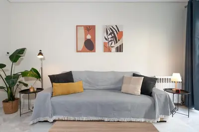 a bedroom with a blue bed with pillows on it at Cozy 1Bdrm Apt/walk to the beach in Athens