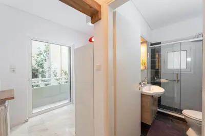 a bathroom with a toilet and a sink at Cozy 1Bdrm Apt/walk to the beach in Athens