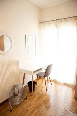 a white table and chair in a room with a window at Spacious Glyfada Golf 4BR -Near Beach + Shops in Athens
