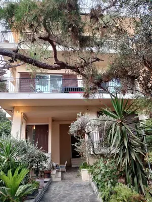 a building with a lot of plants in front of it at Spacious Glyfada Golf 4BR -Near Beach + Shops in Athens