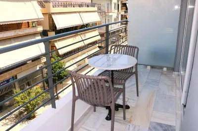 a table and two chairs on a balcony at Piraeus Relax in Piraeus