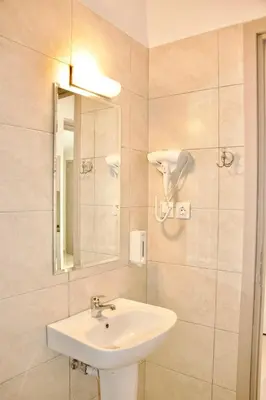 a bathroom with a sink and a mirror at Piraeus Relax in Piraeus
