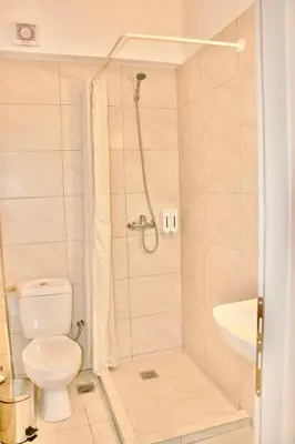 a bathroom with a shower with a toilet and a sink at Piraeus Relax in Piraeus