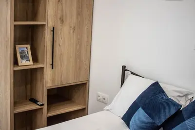 a bedroom with a bed and wooden shelves at ARIS Ampelokipoi in Athens