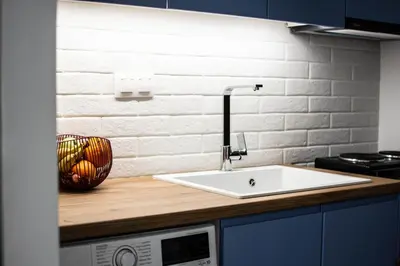a kitchen counter with a sink and a microwave at ARIS Ampelokipoi in Athens