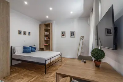 a bedroom with a bed and a table at ARIS Ampelokipoi in Athens