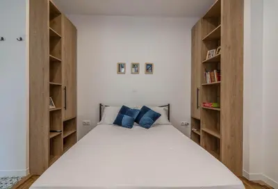 a bedroom with a large bed with wooden shelves at ARIS Ampelokipoi in Athens