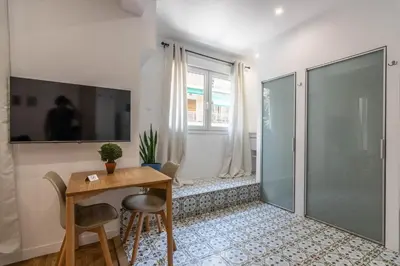a small dining room with a table and a glass shower at ARIS Ampelokipoi in Athens