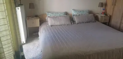 a bedroom with a large bed with two pillows at Pela's studio 10 minutes from the Athens airport in Leondárion