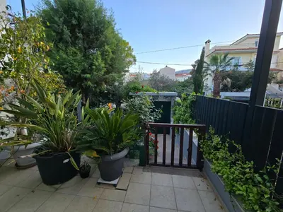 a garden with potted plants and a fence at Pela's studio 10 minutes from the Athens airport in Leondárion