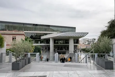 a building with people walking in front of it at Acropolis Museum Apartment by A&A Residences in Athens