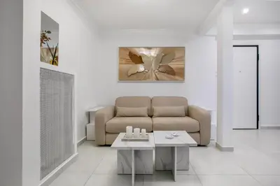 a living room with a couch and a table at Acropolis Museum Apartment by A&A Residences in Athens