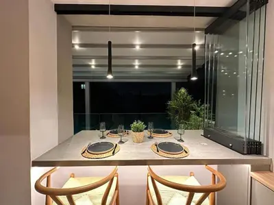 a dining table in a kitchen with two chairs at BlueMotion - SensaBlu #2 in Piraeus