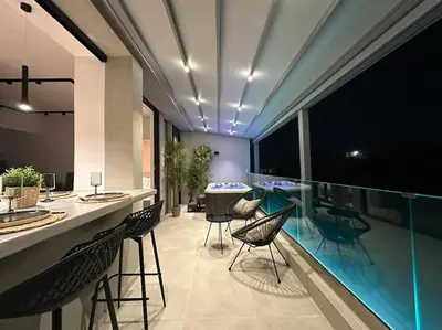 a kitchen with a bar with chairs and a pool at BlueMotion - SensaBlu #2 in Piraeus
