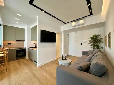 a living room with a couch and a kitchen at BlueMotion - SensaBlu #2 in Piraeus