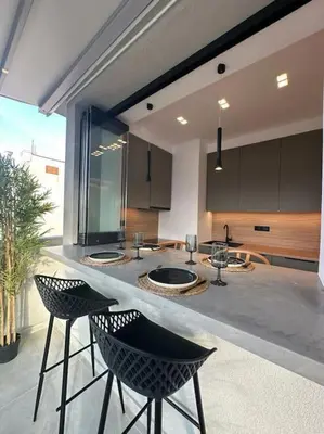 a kitchen with two chairs and a counter with a counter top at BlueMotion - SensaBlu #2 in Piraeus
