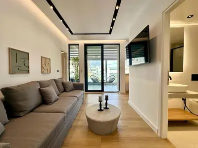 a living room with a couch and a table at BlueMotion - SensaBlu #2 in Piraeus