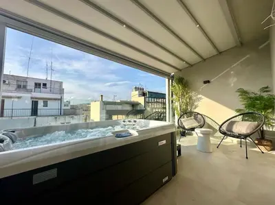 a hot tub on a balcony with a view at BlueMotion - SensaBlu in Piraeus