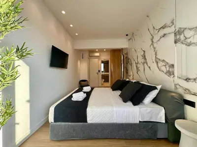 a bedroom with a large bed in a room at BlueMotion - SensaBlu in Piraeus