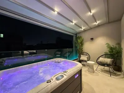 a bathroom with a large tub with purple fluids at BlueMotion - SensaBlu in Piraeus