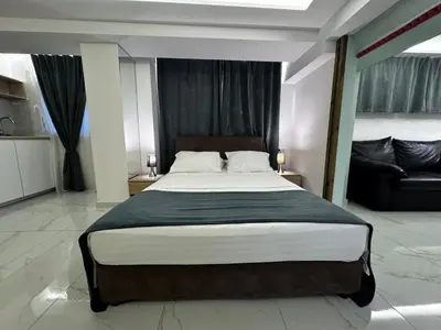 a bedroom with a large bed and a couch at Athens Stay 40 in Athens