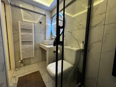 a white bathroom with a toilet and a sink at Athens Stay 40 in Athens