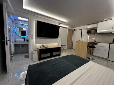 a bedroom with a bed and a flat screen tv at Athens Stay 40 in Athens