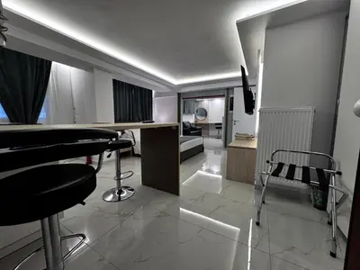 a kitchen and living room with a table and chairs at Athens Stay 40 in Athens