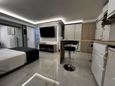 a bedroom with a bed and a desk and a kitchen at Athens Stay 40 in Athens