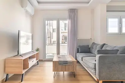 a living room with a couch and a table at Alimos Seabreeze apartment in Athens