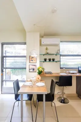 a dining room with a table and chairs at Aiolos GLYFADA luxury apartment in Athens