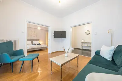 a living room with a couch and a table at Golden Comfort With Courtyard By Greece Apartments in Athens