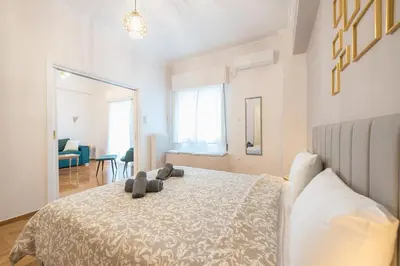 a bedroom with a bed with a teddy bear on it at Golden Comfort With Courtyard By Greece Apartments in Athens
