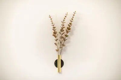 a vase with a plant on a wall at Golden Comfort With Courtyard By Greece Apartments in Athens
