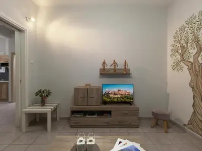 a living room with a tv on a wall at Cozy Athenian One BD, Pistachio Charm in Athens