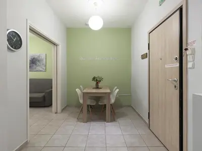a dining room with a table and chairs and a door at Cozy Athenian One BD, Pistachio Charm in Athens