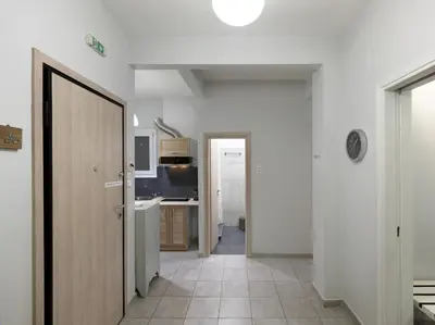 a hallway with a door leading to a kitchen at Cozy Athenian One BD, Pistachio Charm in Athens