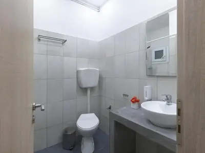 a bathroom with a white toilet and a sink at Cozy Athenian One BD, Pistachio Charm in Athens