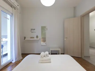 a white bedroom with towels on a bed at Cozy Athenian One BD, Pistachio Charm in Athens
